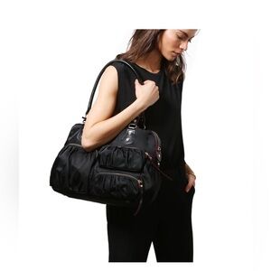 Black MZ Wallace Kate nylon metro tote. 7 main pockets with gold interior.